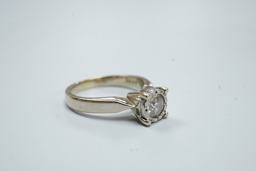 An 18ct and illusion set solitaire diamond ring, the stone weighing approximately 0.30ct, size K, gross weight 4.2 grams.
